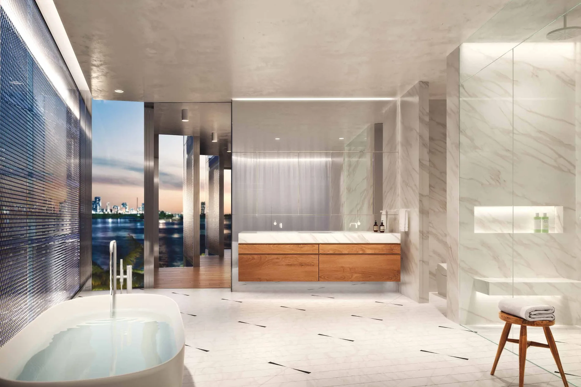 A primary bathroom with a freestanding tub, a floating wood vanity on marble and a mesh screen onto the bay at dusk